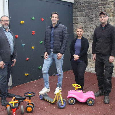 (V.li.) Stefan Beer, Technischer Leiter der VHM, B&uuml;rgermeister Tobias Dannenberg, Kita-Leiterin Seyda Derebasi und Malte Osenbr&uuml;ck, Mitarbeiter des st&auml;dtischen Bauhofs vor der einstigen Einhausung der Trafostation auf dem Kita-Gel&auml;nde, die heute als Spiel- und Nutzfl&auml;che Verwendung findet.